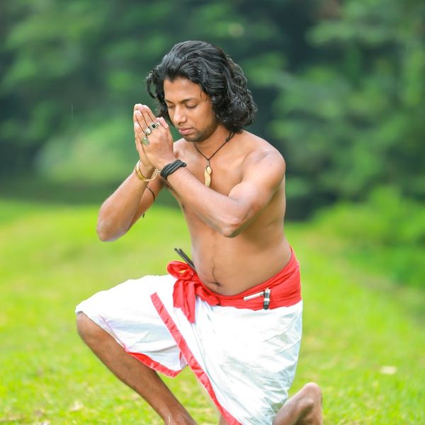 Man in a meditative pose feeling focused and calm.